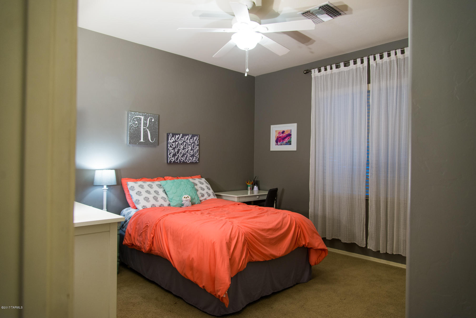 4405 West Crystal Ranch Place Marana, AZ 85658 - Photo 38 of 44 a bedroom with a bed and a chandelier