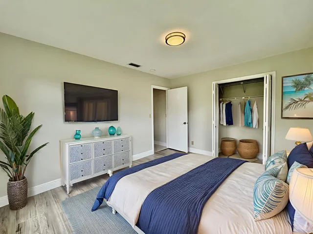 a bedroom with a bed and a flat screen tv