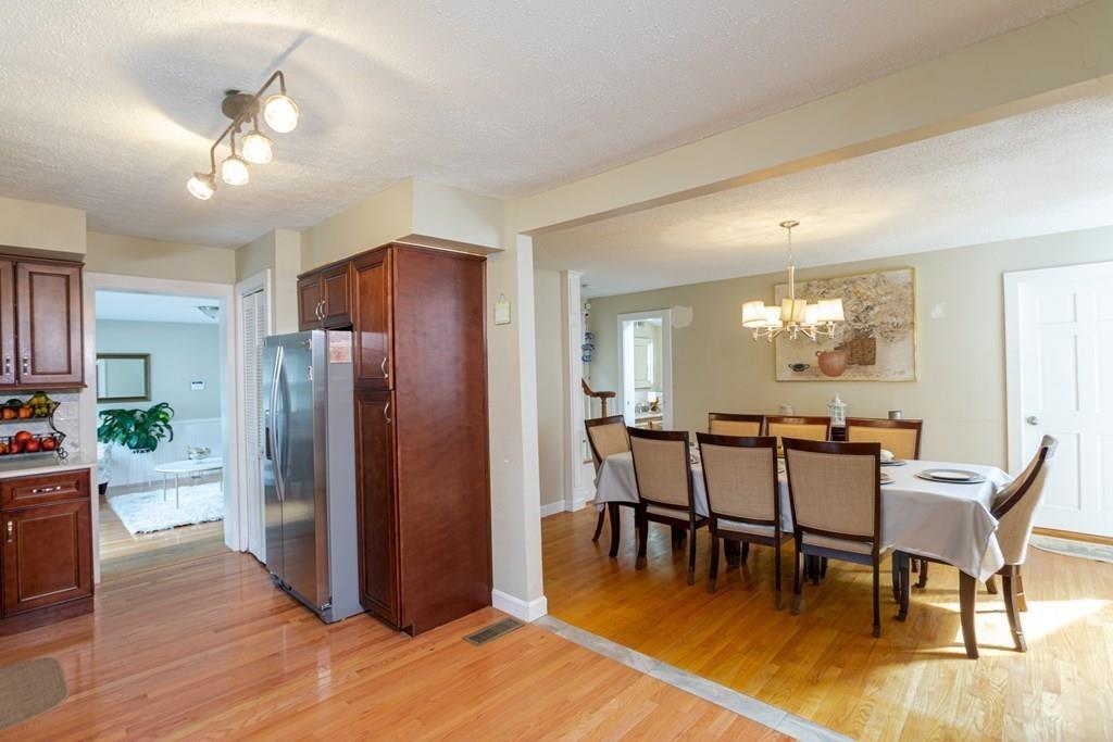 50 Forest Street Bridgewater, MA 02324 - Photo 20 of 42 a dining room with furniture a chandelier and wooden floor