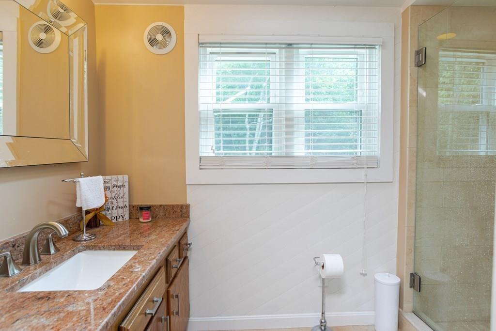 50 Forest Street Bridgewater, MA 02324 - Photo 24 of 42 a bathroom with a granite countertop sink and a mirror