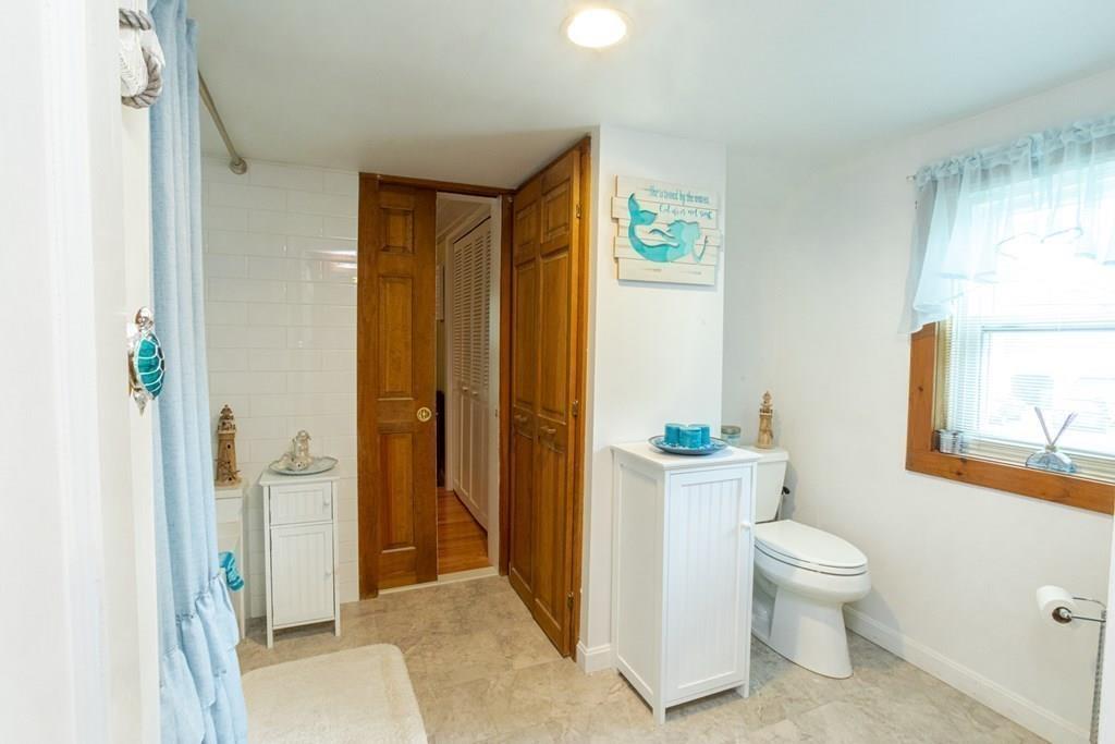 50 Forest Street Bridgewater, MA 02324 - Photo 27 of 42 a bathroom with a granite countertop sink a toilet and shower curtain