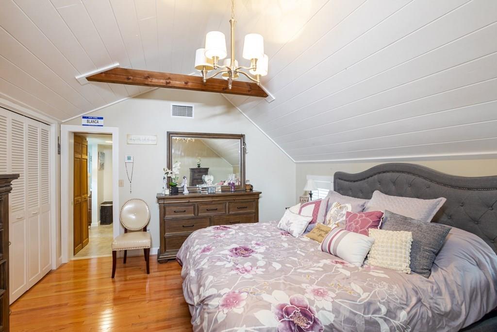 50 Forest Street Bridgewater, MA 02324 - Photo 32 of 42 a bedroom with a bed and wooden floor