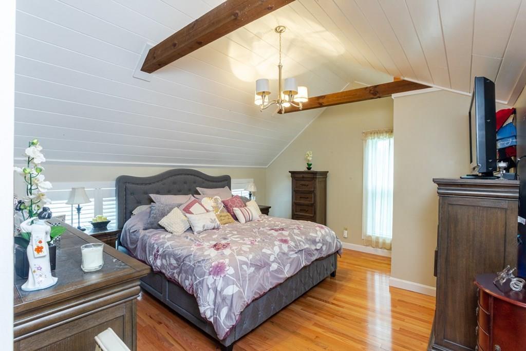 50 Forest Street Bridgewater, MA 02324 - Photo 33 of 42 a bedroom with a bed a flat screen tv and dresser
