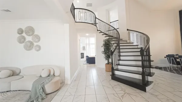 a living room with furniture and a ceiling fan