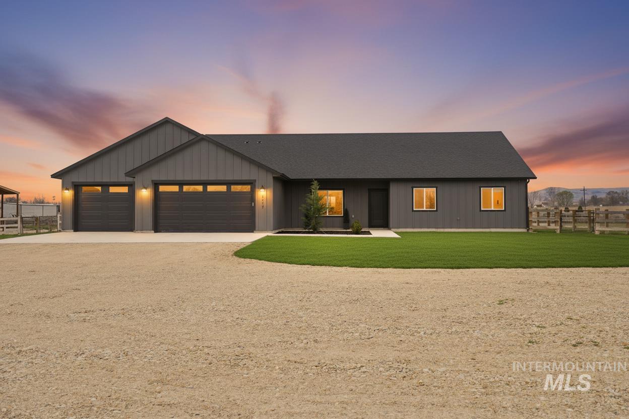 6617 Red Rock Road Marsing, ID 83639 - Photo 1 of 39 Modern inspired farmhouse with driveway, an attached garage, a shingled roof, and board and batten siding