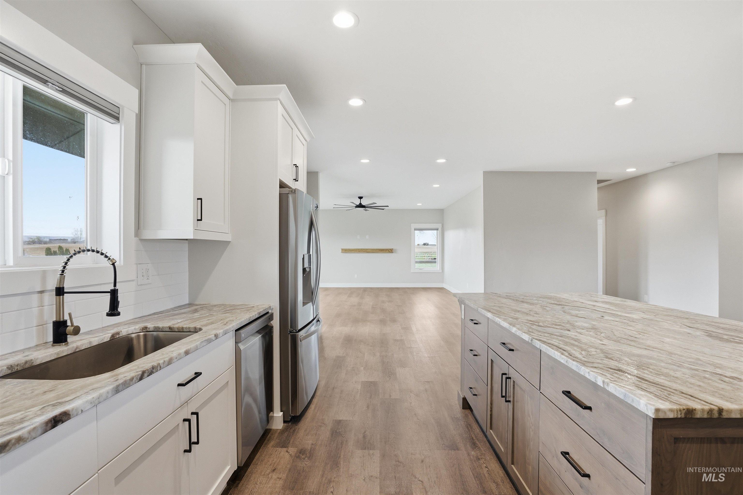 6617 Red Rock Road Marsing, ID 83639 - Photo 39 of 39 Kitchen featuring light stone countertops, open floor plan, recessed lighting, dark wood-style flooring, and stainless steel appliances