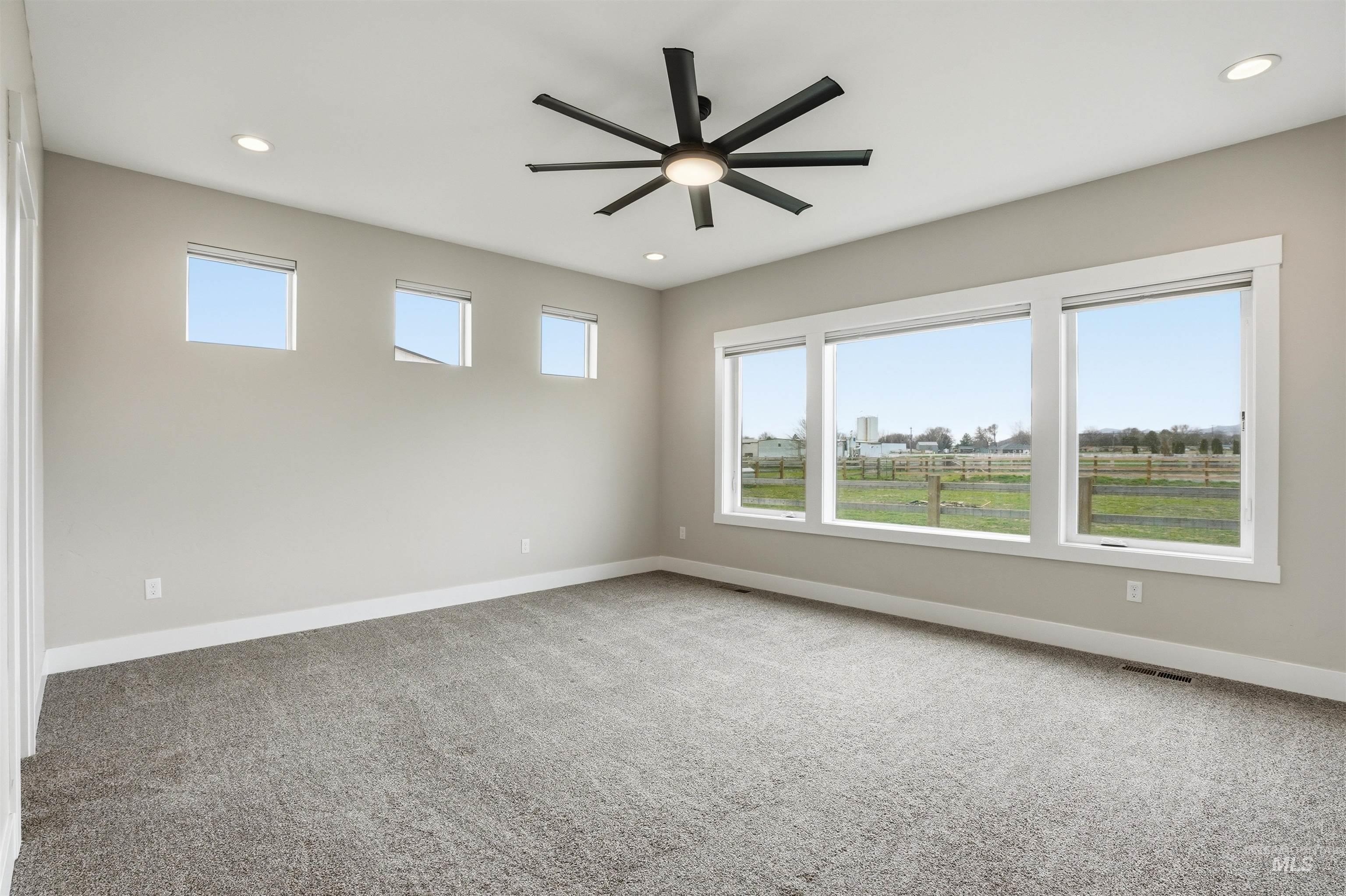 6617 Red Rock Road Marsing, ID 83639 - Photo 13 of 39 Unfurnished room featuring light colored carpet, a ceiling fan, and recessed lighting