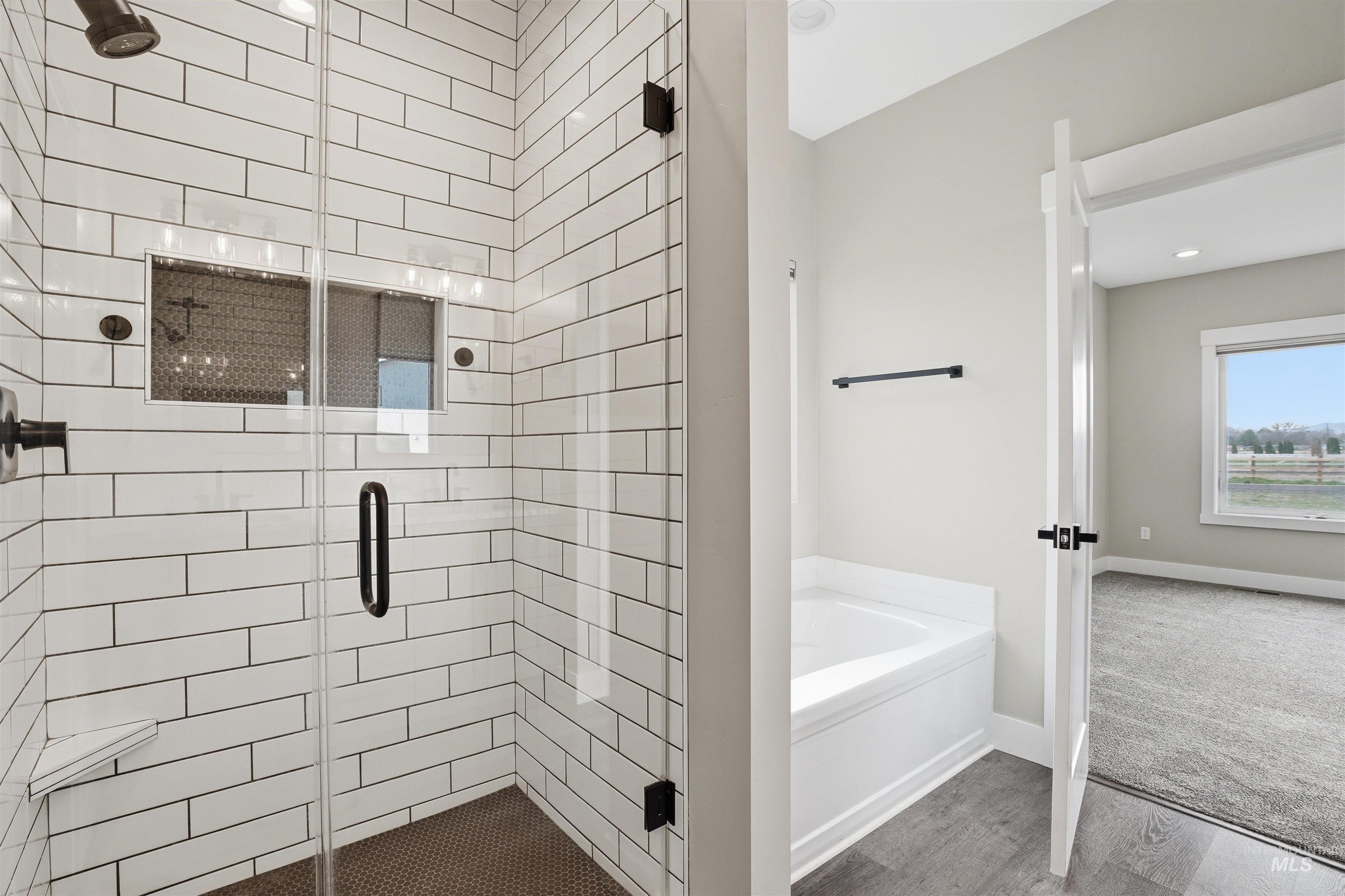 6617 Red Rock Road Marsing, ID 83639 - Photo 16 of 39 Bathroom featuring a stall shower, a bath, and wood finished floors