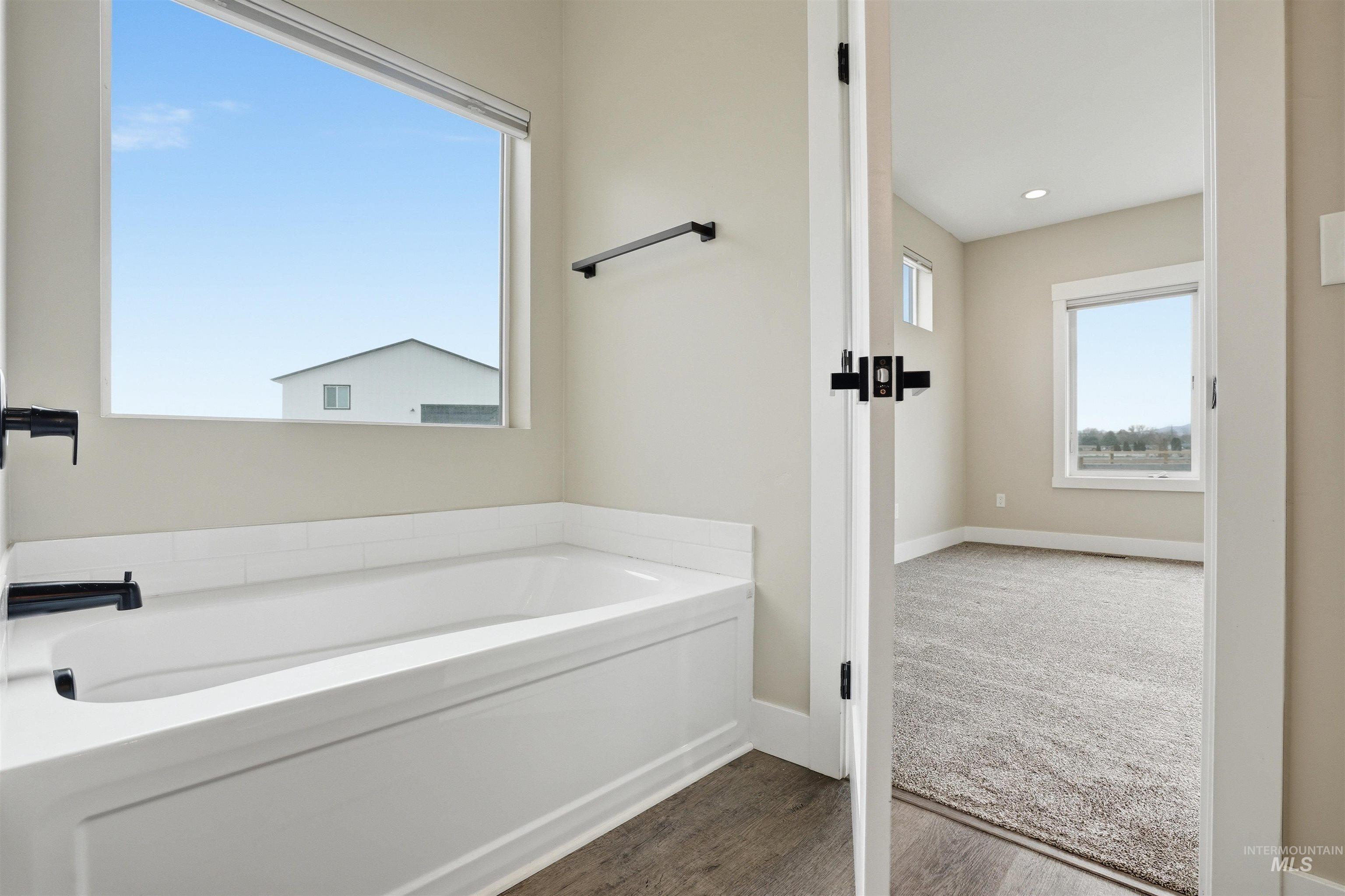 6617 Red Rock Road Marsing, ID 83639 - Photo 18 of 39 Full bathroom featuring a garden tub and dark wood finished floors