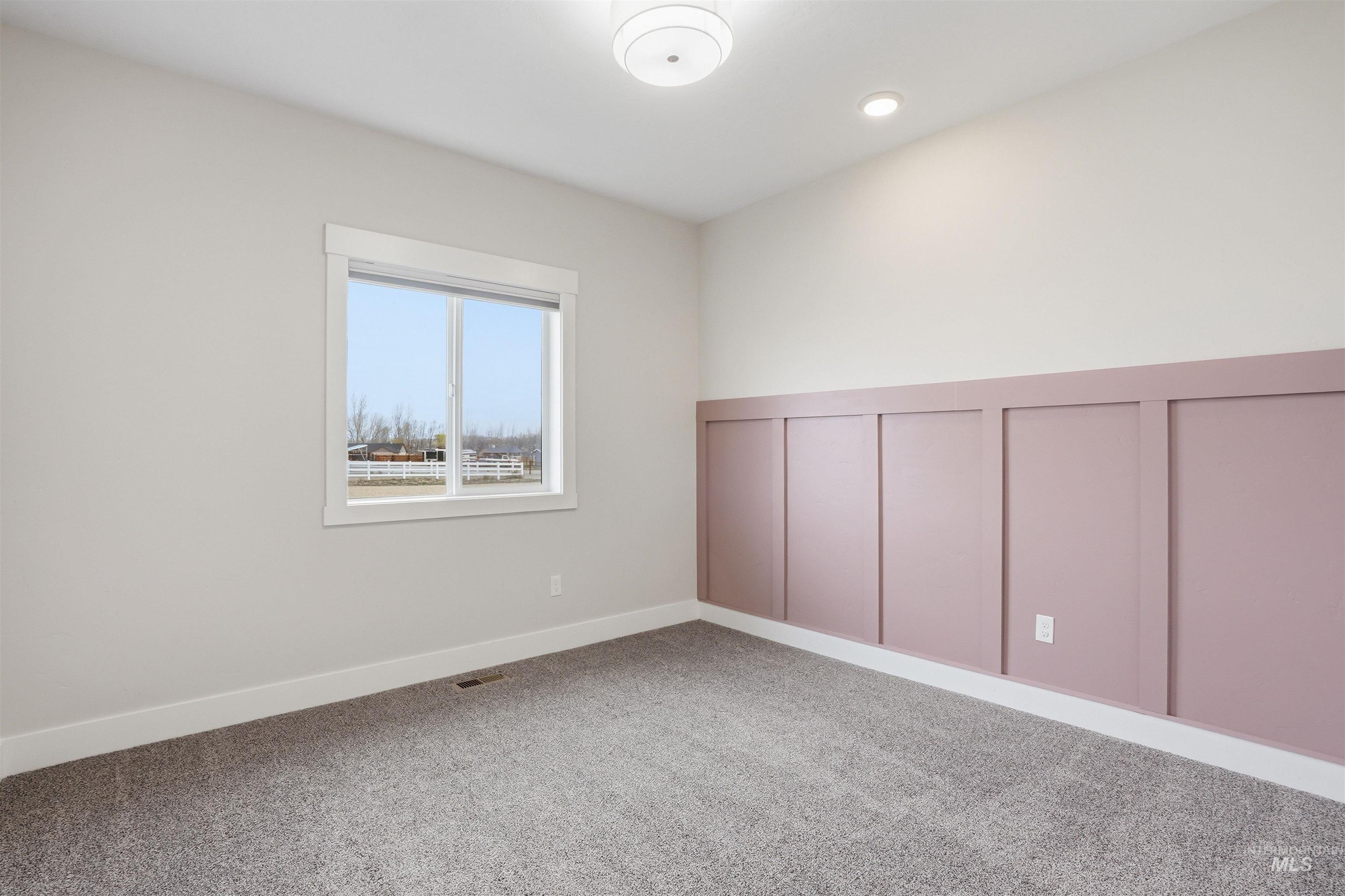 6617 Red Rock Road Marsing, ID 83639 - Photo 21 of 39 Empty room with a decorative wall, a wainscoted wall, and light colored carpet