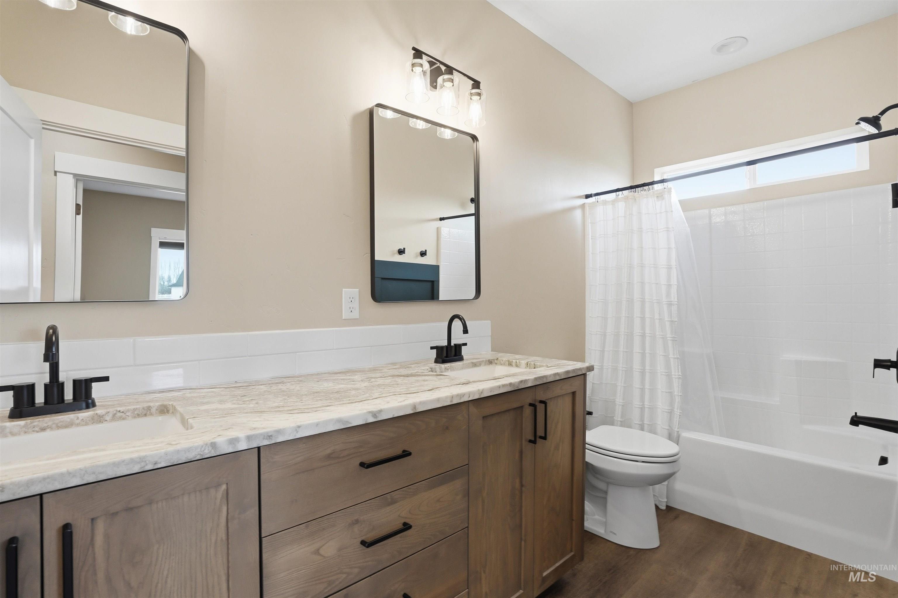 6617 Red Rock Road Marsing, ID 83639 - Photo 23 of 39 Full bathroom with shower / bath combo with shower curtain, double vanity, and dark wood-style flooring