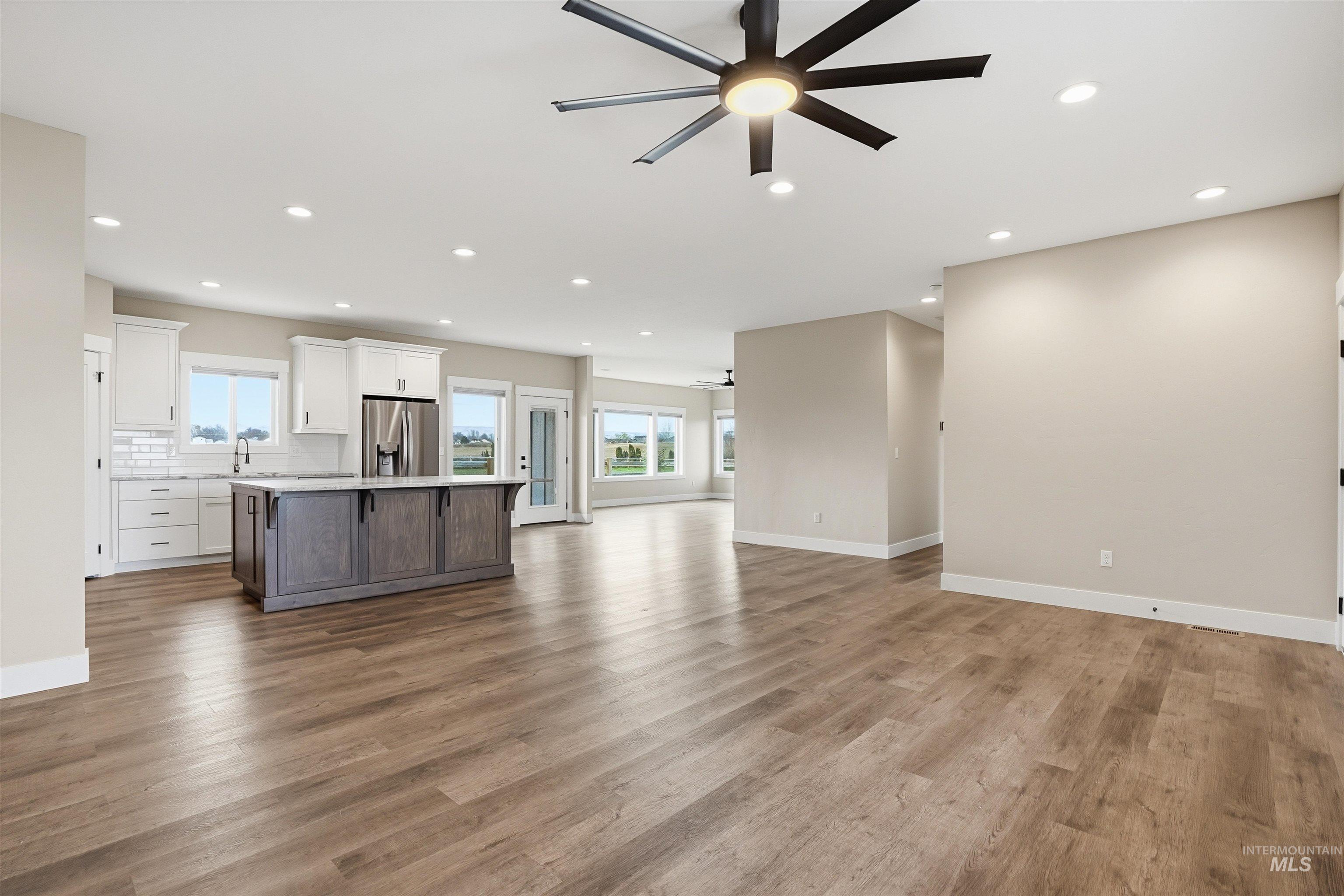 6617 Red Rock Road Marsing, ID 83639 - Photo 24 of 39 Unfurnished living room featuring a ceiling fan, recessed lighting, and dark wood-style flooring