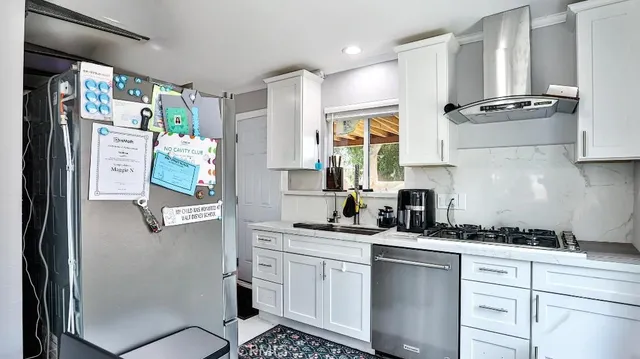 a kitchen with stainless steel appliances a refrigerator sink and cabinets