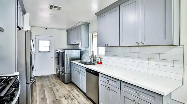 a kitchen with a sink and refrigerator