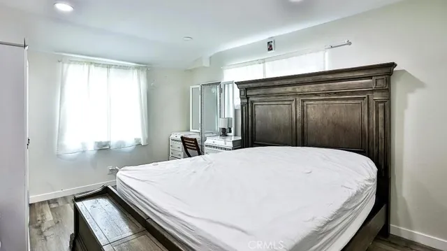 a bed sitting in a bedroom next to a window