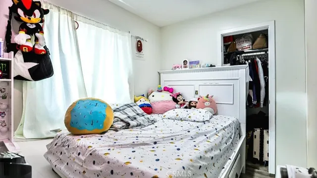 a bedroom with a bed and cabinets