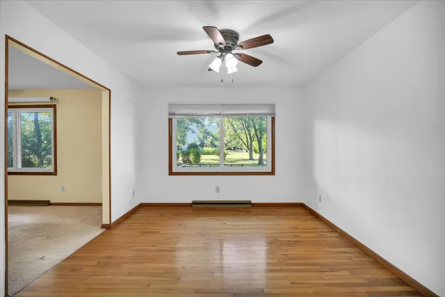 wooden floor in an empty room with a window