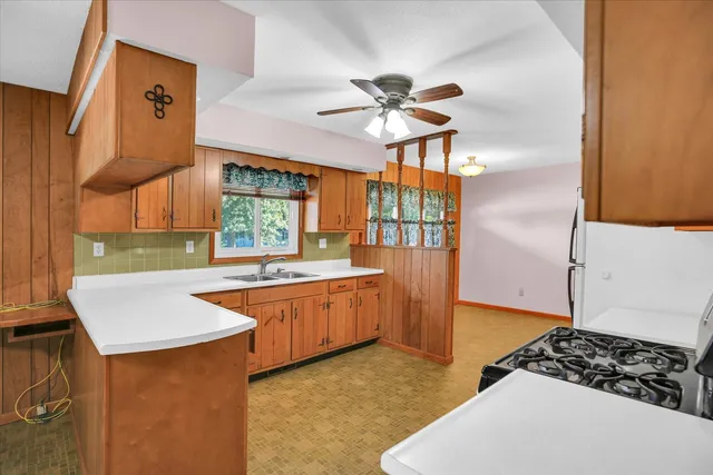 a kitchen with stainless steel appliances granite countertop a sink and a refrigerator
