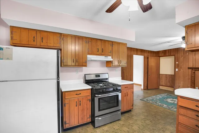 a kitchen with stainless steel appliances a refrigerator a stove a sink and a refrigerator