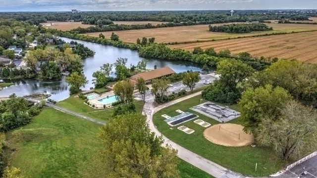 an aerial view of lake residential house with outdoor space and mountain view