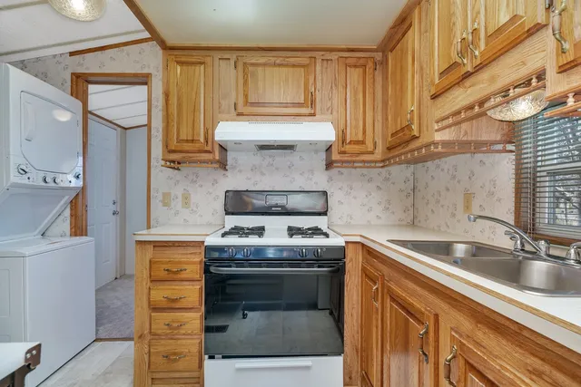 a kitchen with a sink cabinets and a wooden floor
