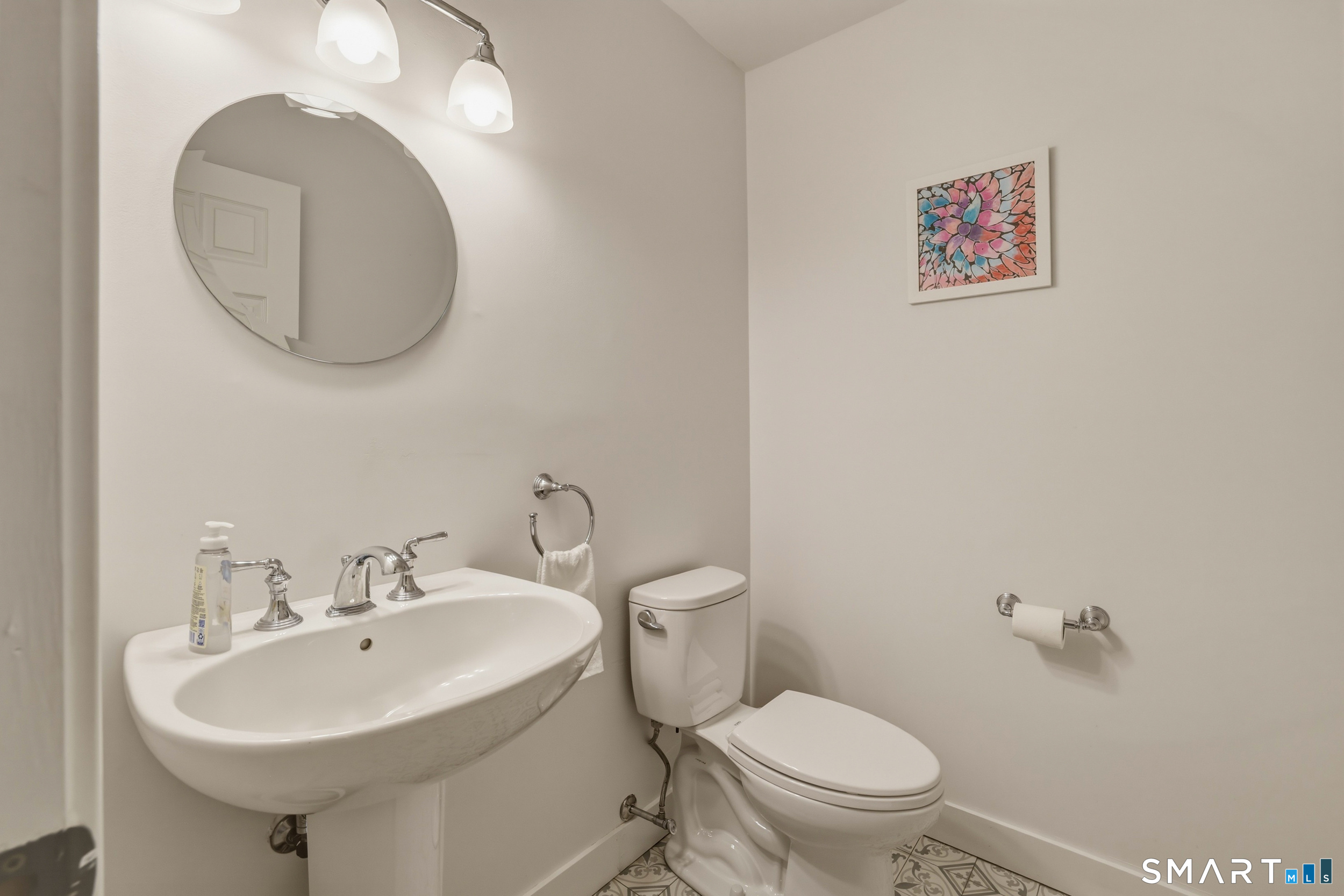 51 Sugar Loaf Road Guilford, CT 06437 - Photo 11 of 40 a bathroom with a sink a mirror and a toilet