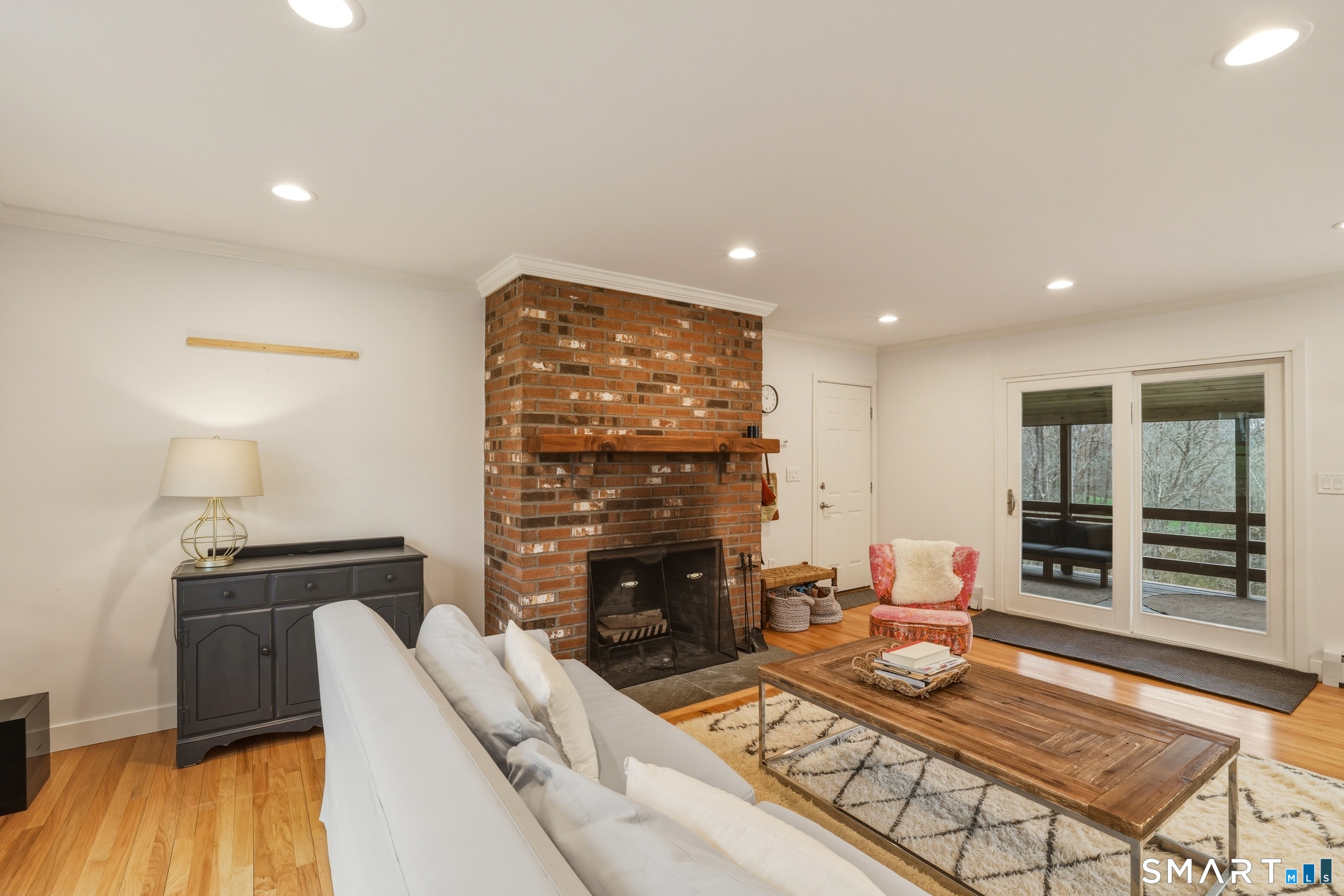 51 Sugar Loaf Road Guilford, CT 06437 - Photo 13 of 40 a living room with fireplace furniture and a wooden floor