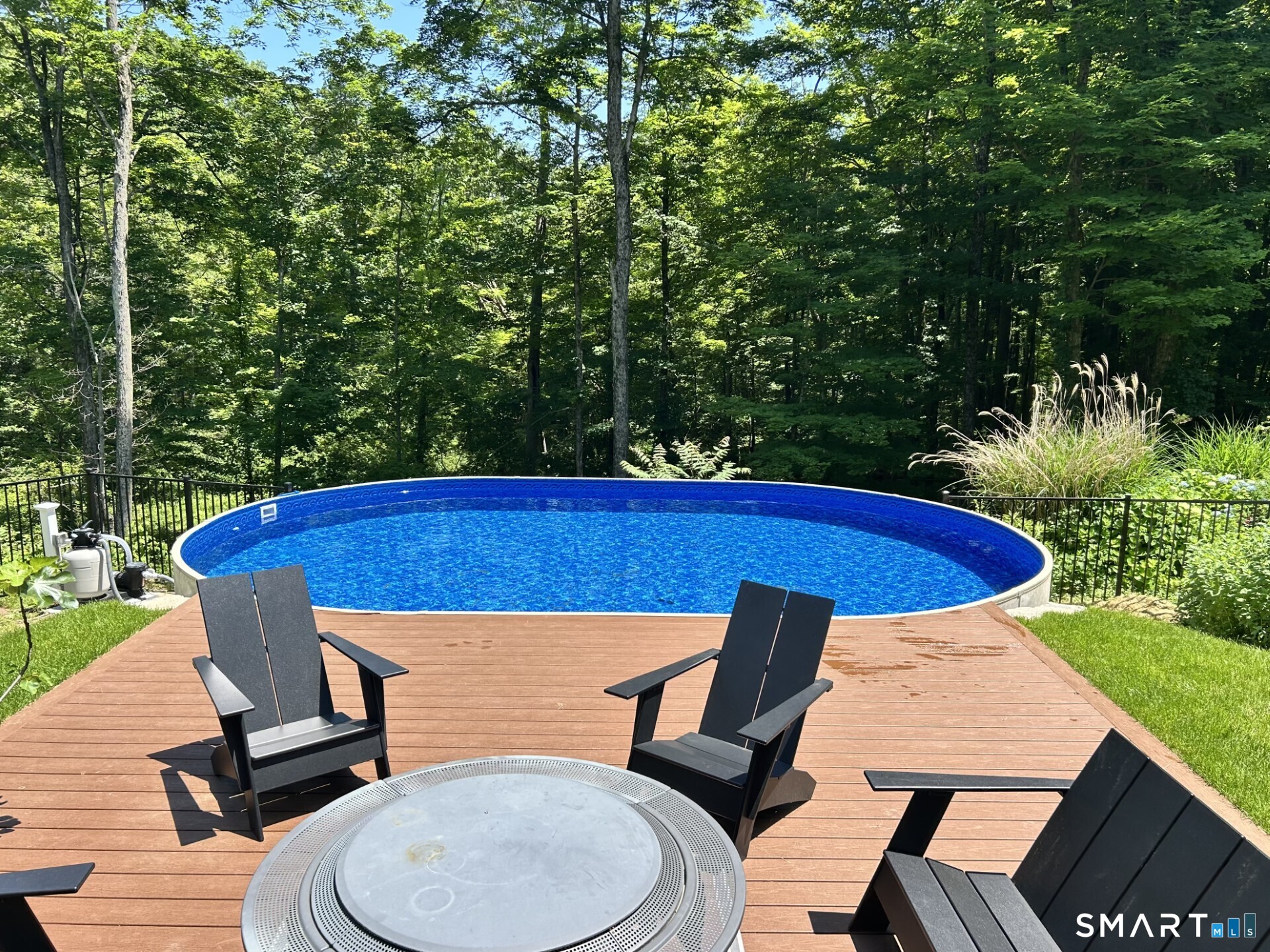 51 Sugar Loaf Road Guilford, CT 06437 - Photo 15 of 40 a blue swimming pool with outdoor seating