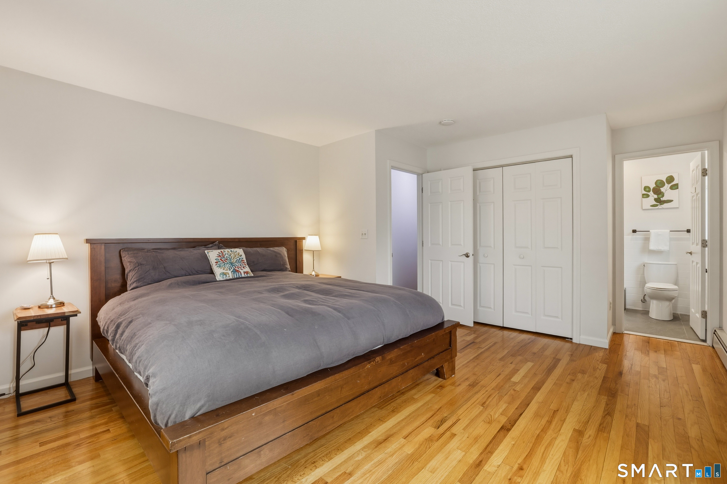 51 Sugar Loaf Road Guilford, CT 06437 - Photo 16 of 40 a bedroom with a bed and wooden floor