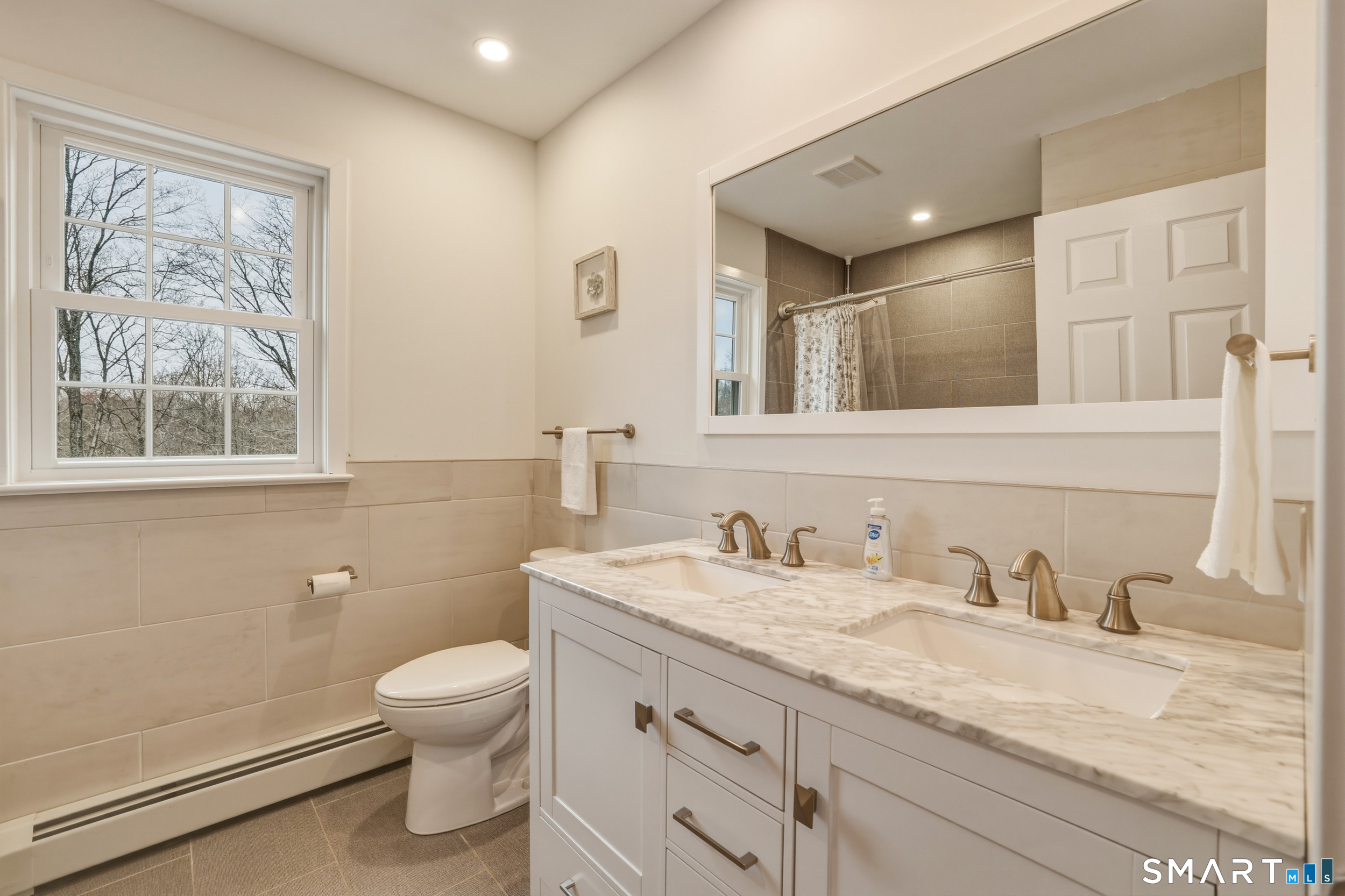 51 Sugar Loaf Road Guilford, CT 06437 - Photo 22 of 40 a bathroom with a granite countertop toilet sink and mirror
