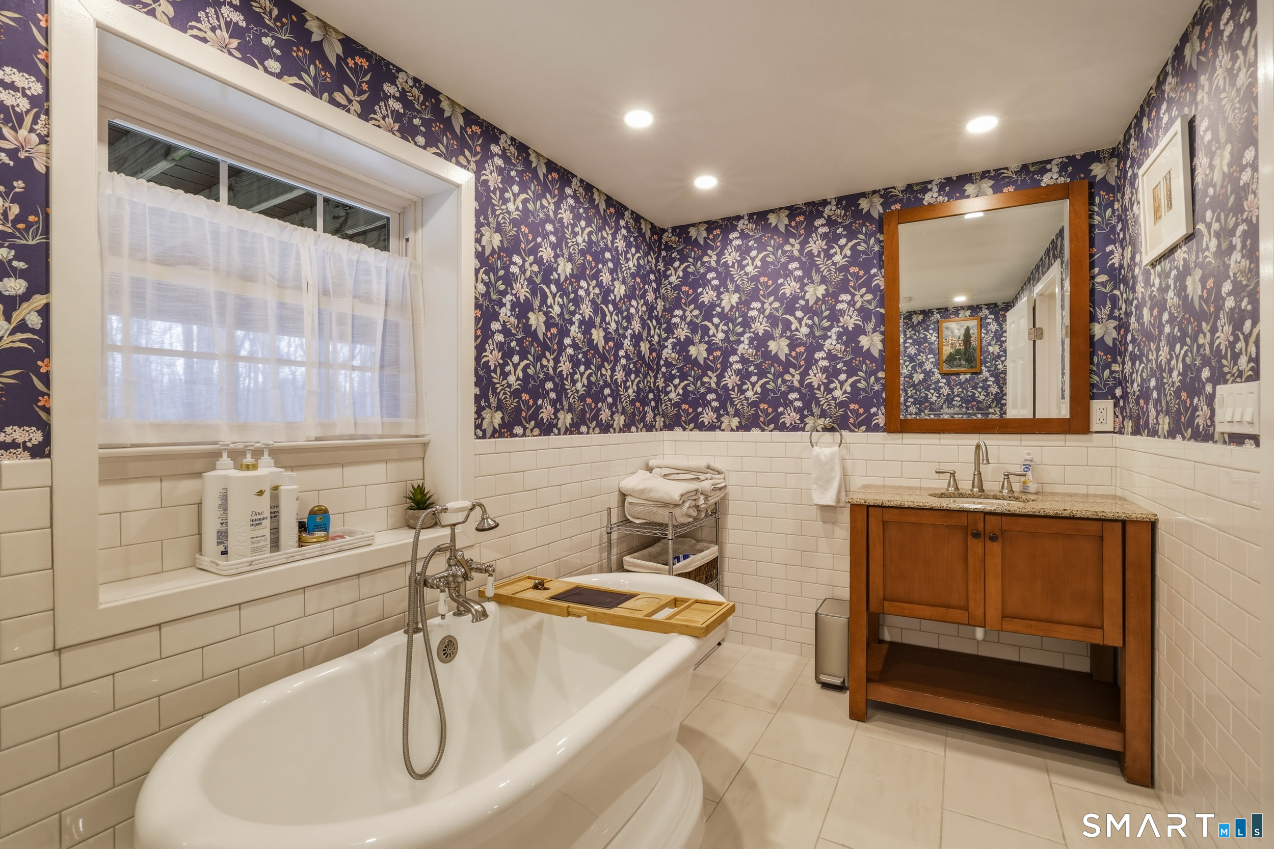 51 Sugar Loaf Road Guilford, CT 06437 - Photo 28 of 40 a bathroom with a sink and a mirror