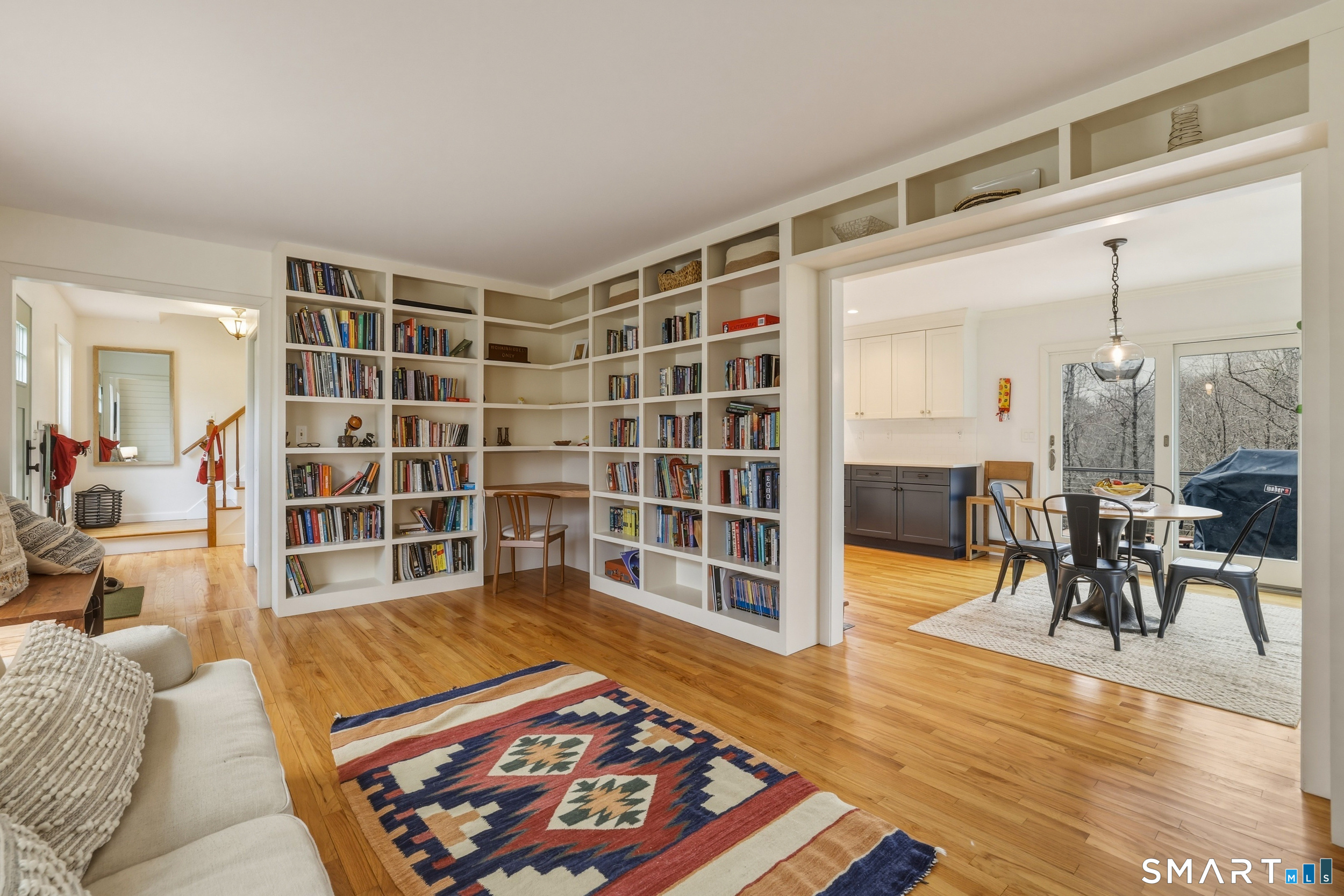 51 Sugar Loaf Road Guilford, CT 06437 - Photo 4 of 40 a living room with furniture and a dining table with wooden floor