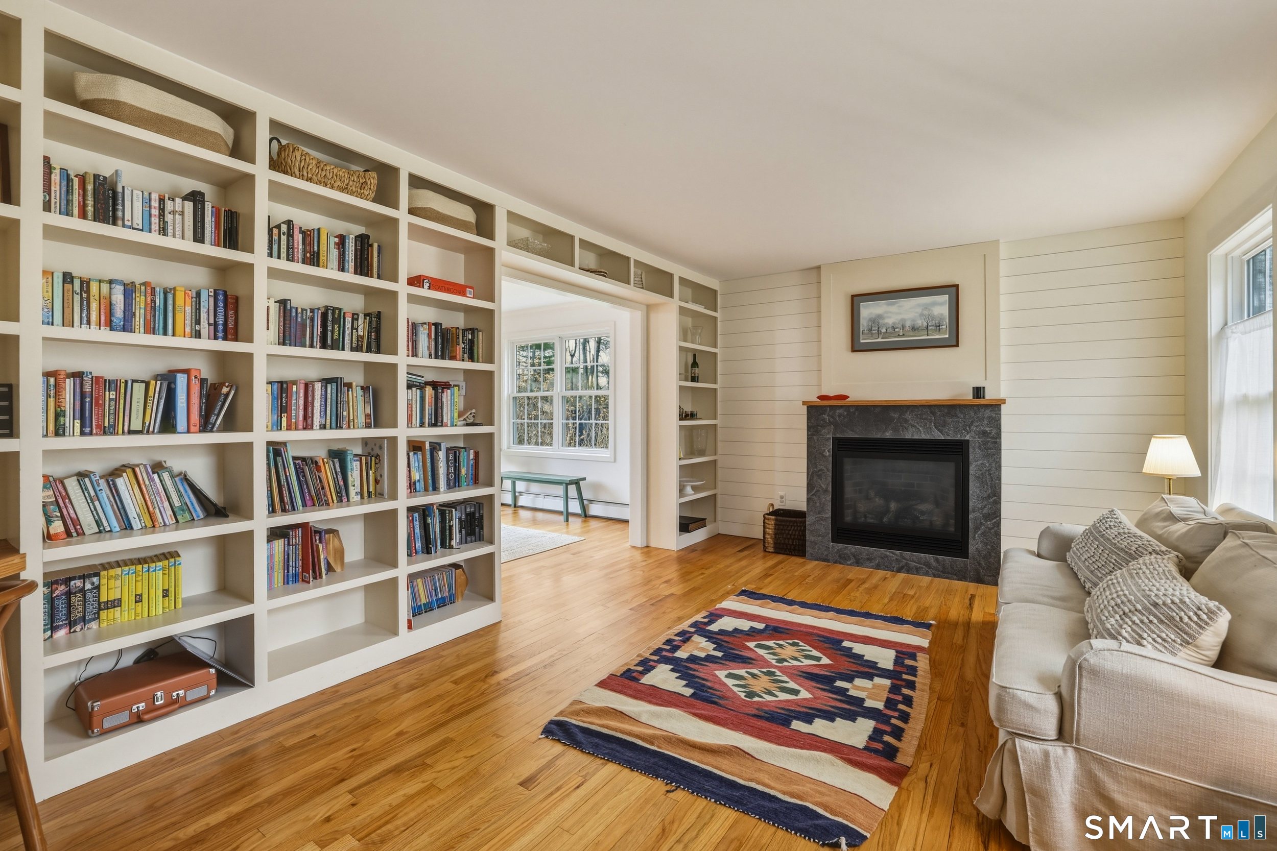 51 Sugar Loaf Road Guilford, CT 06437 - Photo 5 of 40 a living room with furniture and a book shelf