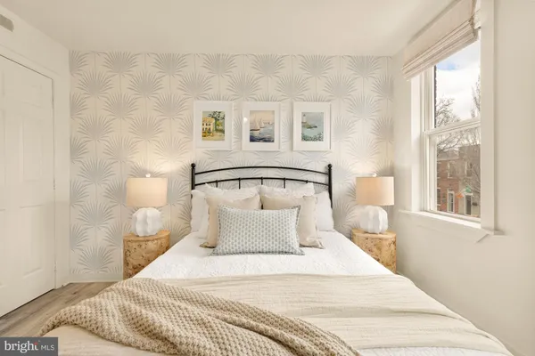 a bedroom with a large bed and a window