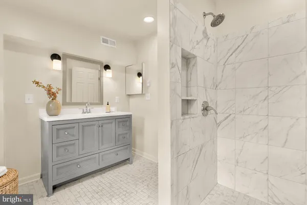 a bathroom with a double vanity sink a mirror and a shower