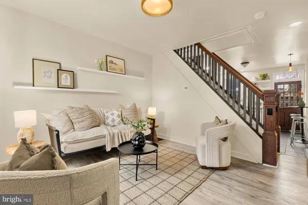a living room with furniture and a potted plant