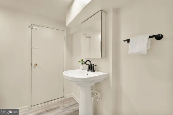 a bathroom with a sink a mirror and shower