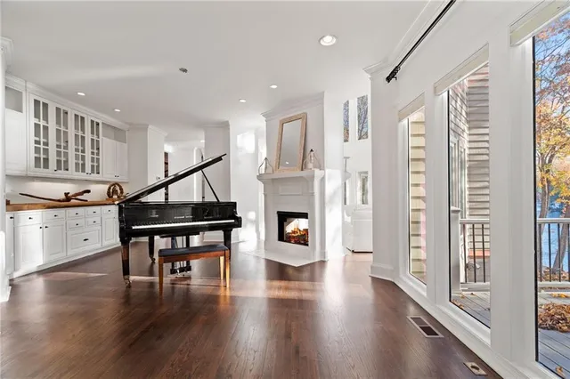 a spacious bedroom with a bed and a flat screen tv