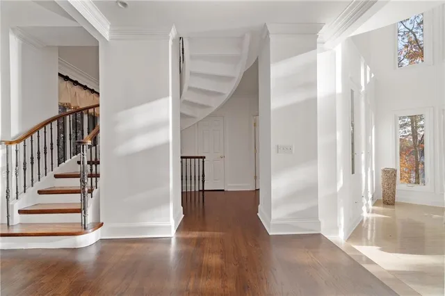 a living room with furniture and floor to ceiling windows