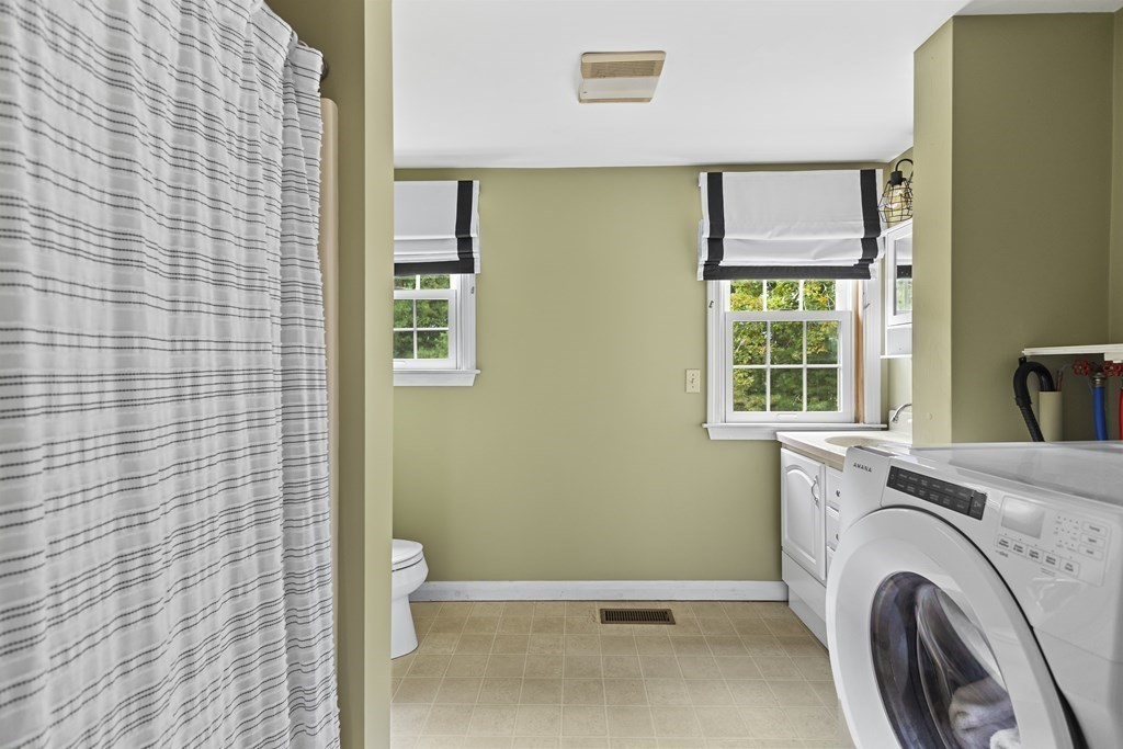 18 Pierceville Road Wareham, MA 02576 - Photo 13 of 29 a view of a bathroom with washing machine and window