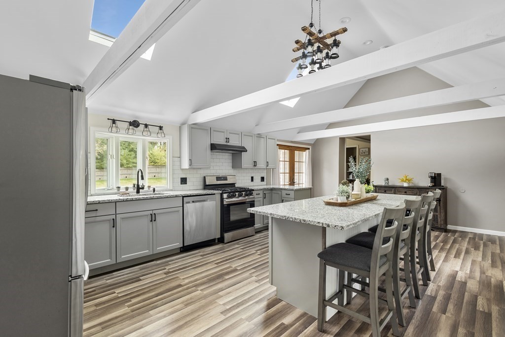 18 Pierceville Road Wareham, MA 02576 - Photo 9 of 29 a kitchen with a table chairs appliances and cabinets