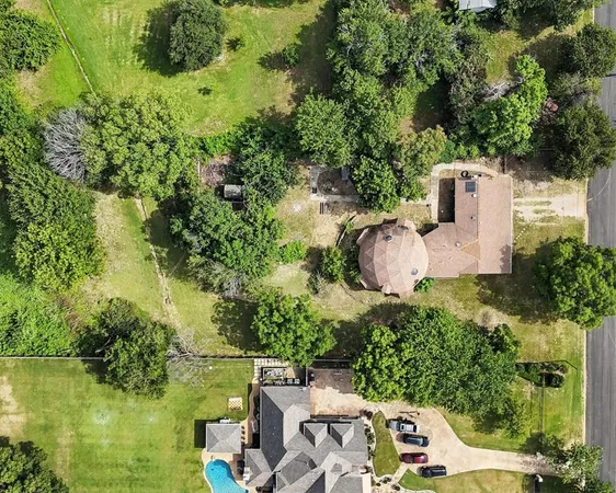 an aerial view of a house with a yard lake lake and outdoor seating