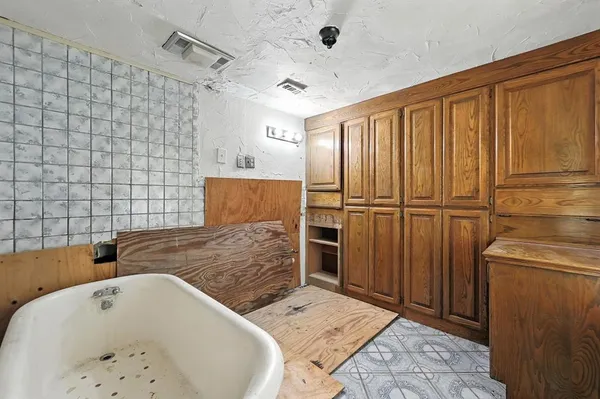 a bathroom with a bathtub and shower