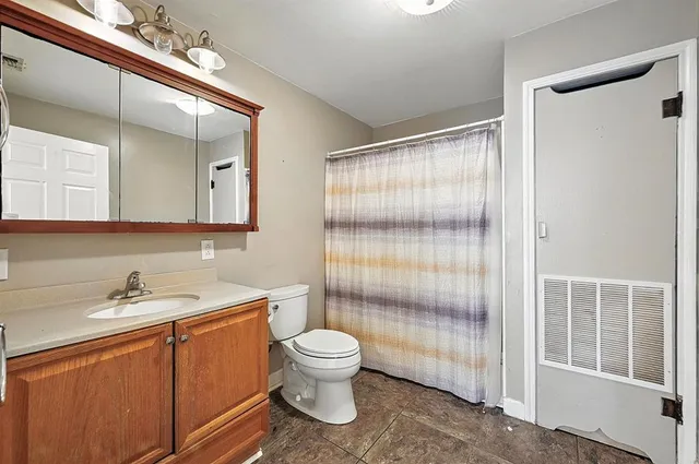 a bathroom with a sink toilet and shower