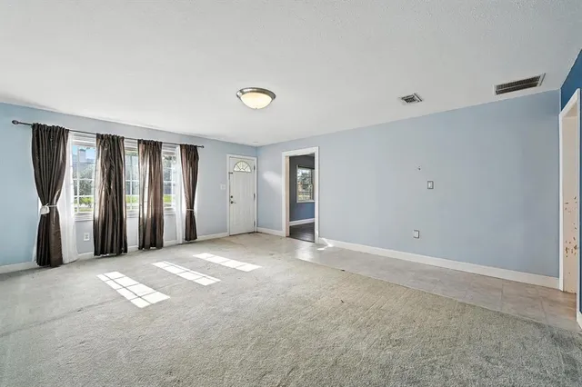 a view of an empty room with a window