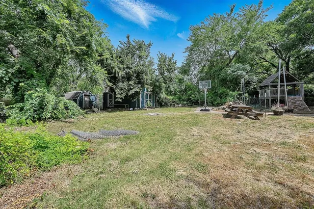 a backyard of a house with table and chairs