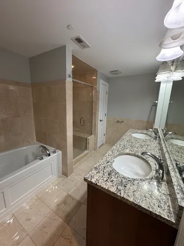 a bathroom with a granite countertop sink a toilet and bathtub