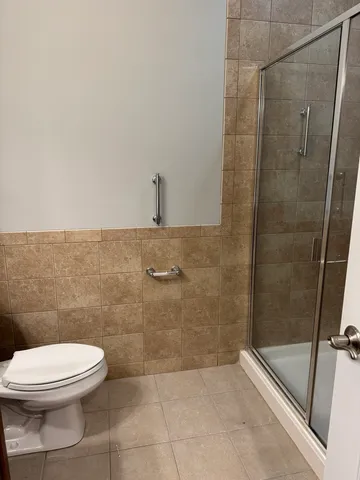 a bathroom with a toilet and a shower