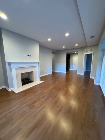 a view of an empty room with a fireplace