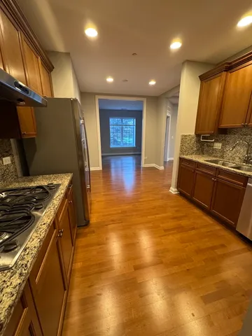 a kitchen with stainless steel appliances granite countertop a stove and a refrigerator